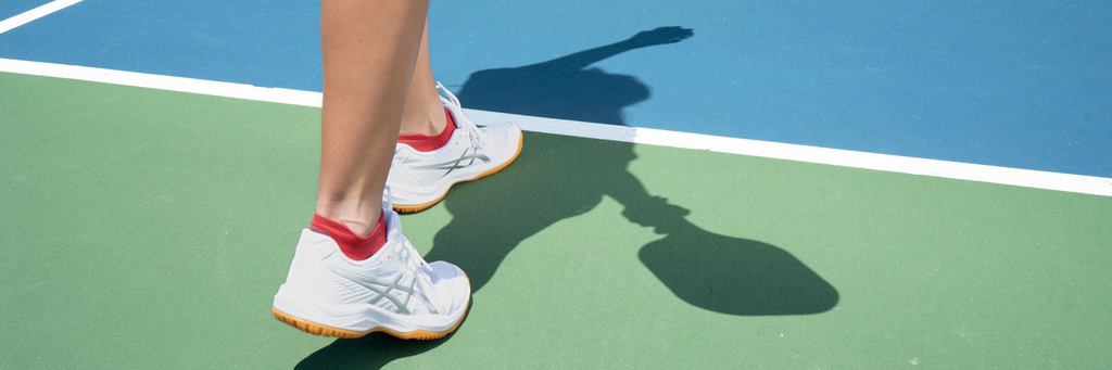 Woman playing pickleball wearing red pickleball sock | OS1st