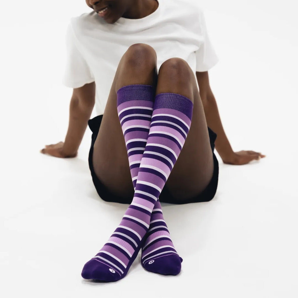 woman wearing purple with stripes wellness compression socks | OS1st