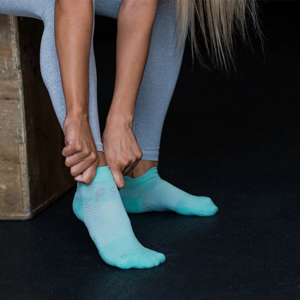 Female wearing mint no show plantar fasciitis socks | OS1st