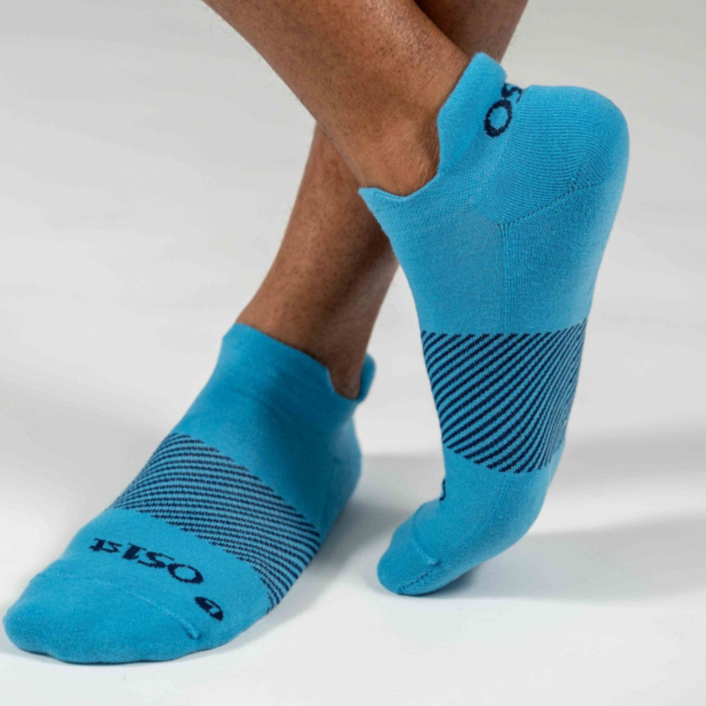 A man standing with his ankles crossed wearing Wicked Comfort socks in Carolina Blue