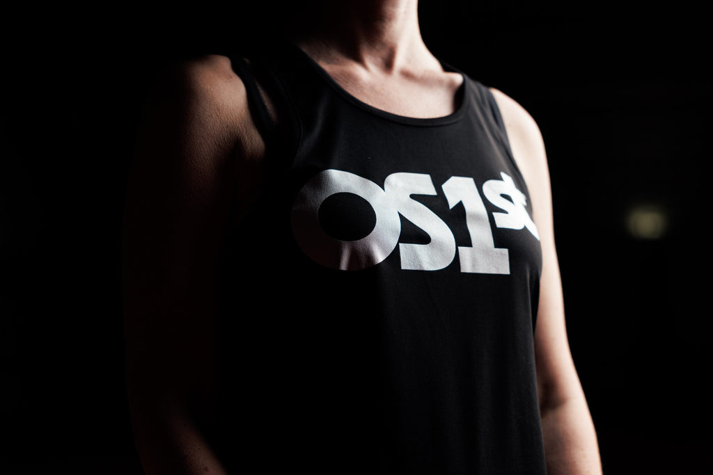 Woman wearing black OS1st logo tank