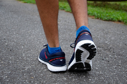 a man walking in the no show length FS4 socks in blue